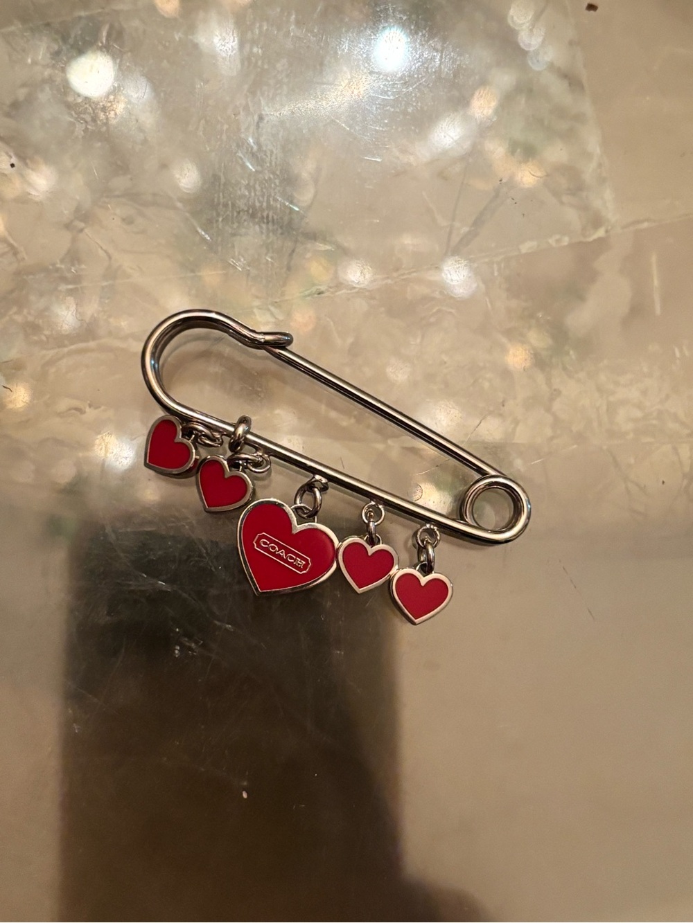 Coach Silver-Tone Safety Pin Brooch with Red Heart Charms